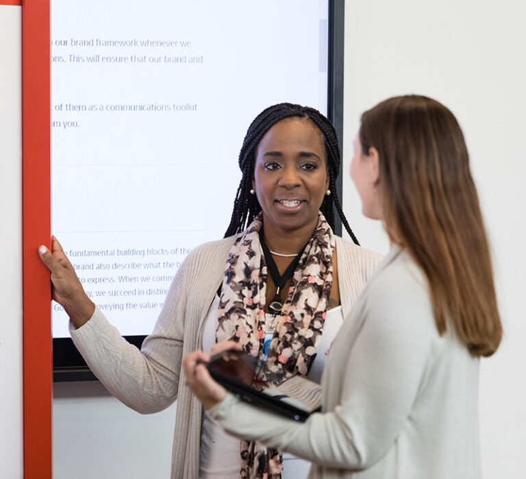 Two female colleagues having a discussion in the workplace